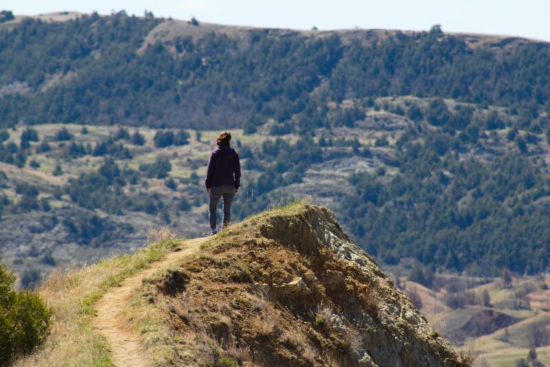 Person Hiking on Mountain Path