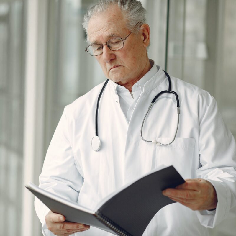 doctor-in-uniform-reading-clinical-records