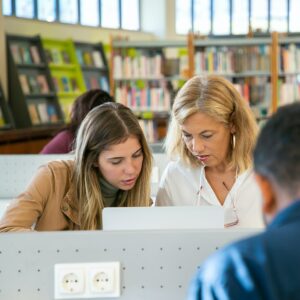 focused-student-preparing-university-project-with-teacher