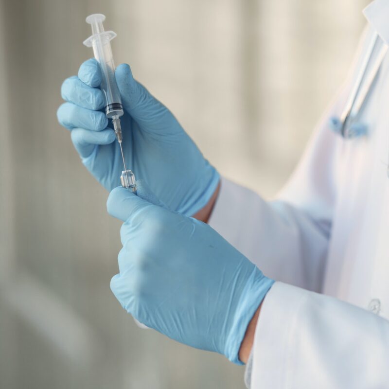 person-in-white-long-sleeve-shirt-holding-injection