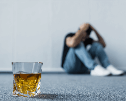 depressed man near alcohol