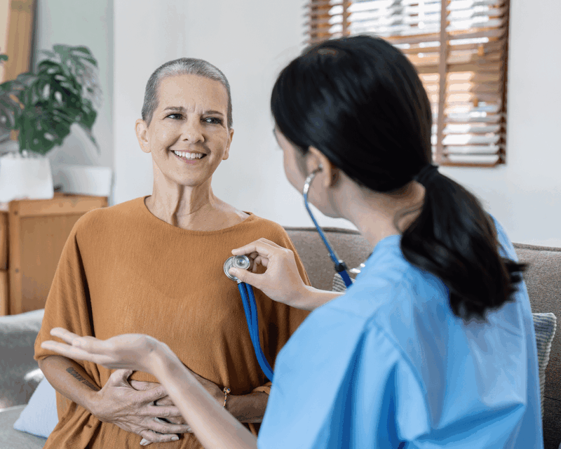 doctor using stethoscope on patient