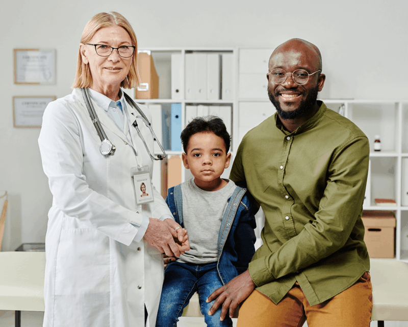 father and son with pediatrician