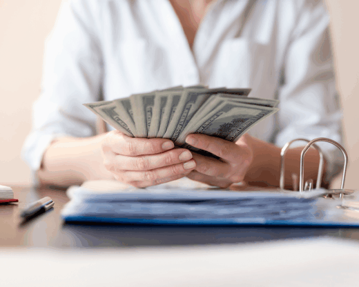 woman holding hundred dollar bills
