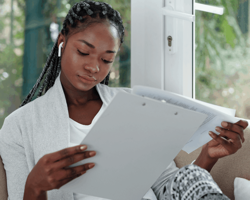 woman reading summary of benefits and coverage