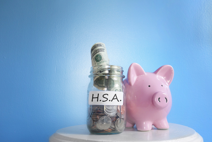 Health Savings Account ( HSA ) coin jar with piggy bank.